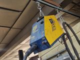 a blue and yellow crane hanging from the ceiling