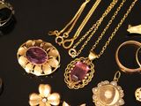 many different types of jewelry on a black table