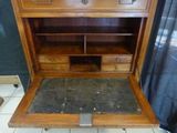 a wooden desk with a marble top in a room