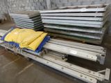 several pieces of metal are stacked on top of each other in a warehouse