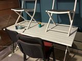 two chairs and a table in a room with blue walls
