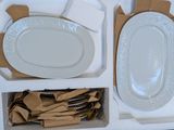 a tray with plates, napkins, and napkins in it