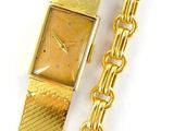 an image of a gold watch and a gold bracelet on a white surface