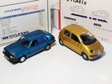 two toy cars sitting next to each other on a table