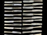 six pairs of silverware knives and a pair of silverware knives on a black background