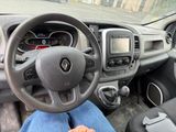 a person sitting in the driver ' s seat of a car