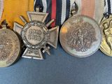 several medals and medals are on a ribbon on a blue surface