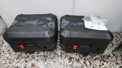 two suitcases that are sitting on a tiled floor