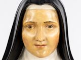 a statue of a woman wearing a nun ' s headdress