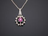 a pink sapphire and diamond pendant on a silver chain