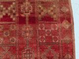 a close up of a red rug with a pattern on it