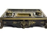 a black and gold desk with a glass top