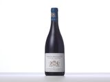 a bottle of red wine sitting on top of a table