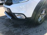 a close up of a white suv parked in a parking lot