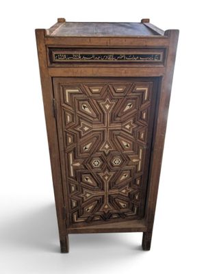 an image of a wooden cabinet with a decorative design on the door