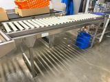 a conveyor belt with boxes on it in a factory
