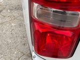 a close up of the tail light of a white truck