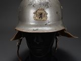 a silver helmet with a crest on the side of it