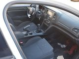 the interior of a car with the door open and the driver ' s seat down