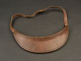 an old leather purse with a strap on a black surface