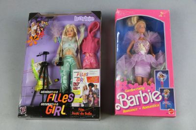 two barbie dolls are sitting next to each other on a table
