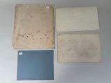 four pieces of paper are sitting on top of a table