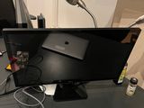 a desk with a laptop and a monitor on it