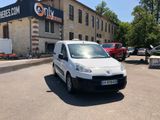 a small white van parked in front of a building