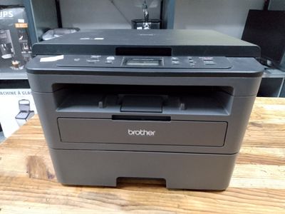 a printer sitting on top of a wooden table