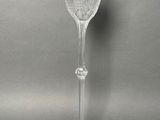 the stem of a wine glass with a flower design on it