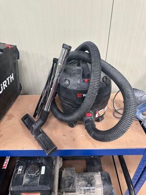 a small table with a vacuum and other tools on it