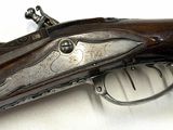 a close up of a gun on a white surface with a white background