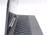 a laptop with a pen sitting on top of it