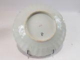 a white plate with a brown rim sitting on a table