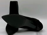the black shoes are on a white surface with a white background