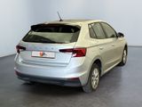the rear end of a silver car in a white room
