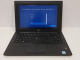 a laptop computer sitting on a table with a blue screen