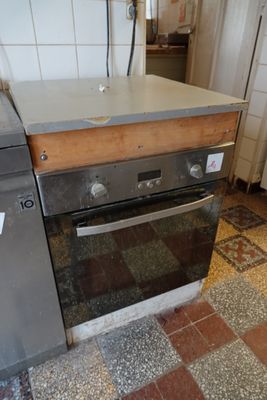 a stove and oven in a kitchen with a tiled floor