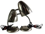 pair of chromed desk lamps with cord and plugged plugged