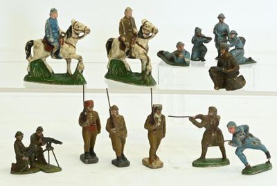 many figurines of soldiers on display on a white surface