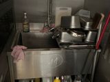 a kitchen with a sink and a lot of pots and pans