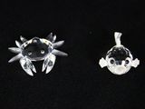 two pieces of clear glass with black and white designs on them