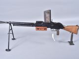 an old machine gun on a stand on a white surface
