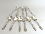 a lot of silver spoons and forks on the table