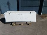 a white box sitting on a pallet on the ground