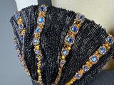 a close up of a woman ' s bra top with a beaded belt