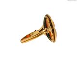 a close up of a gold ring with a stone in the middle