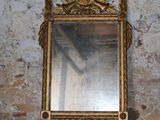 a mirror sitting on a table in front of a brick wall
