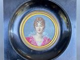 a picture of a woman in a pink dress on a plate
