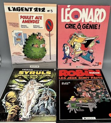 Trois bandes dessinées sont posées les unes à côté des autres sur une table.